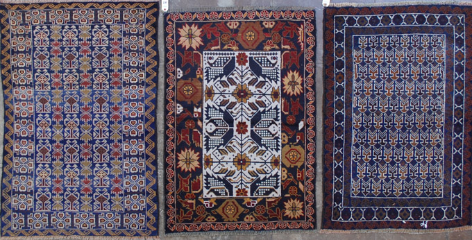 Appraisal: THREE AFGHAN BELOUCHI TRIBAL AREA RUGS all hand knotted wool