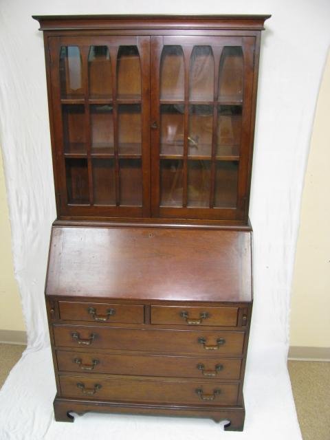 Appraisal: Drop front secretary desk with glass doors Desk interior has