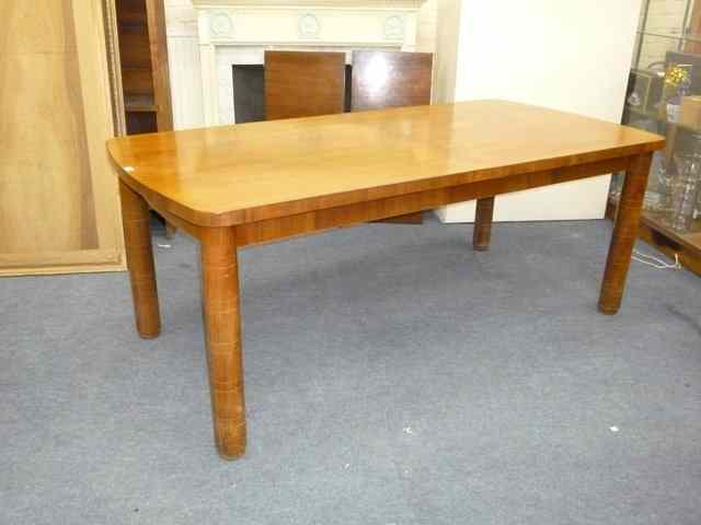 Appraisal: A 'S GORDON RUSSELL WALNUT EXTENDING DINING TABLE with bowed