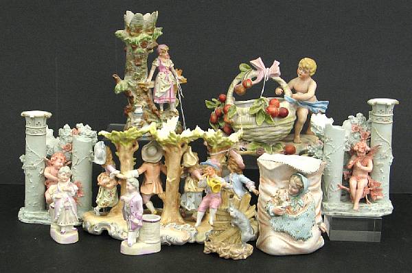 Appraisal: An assembled group of German bisque figural vases and matchstick