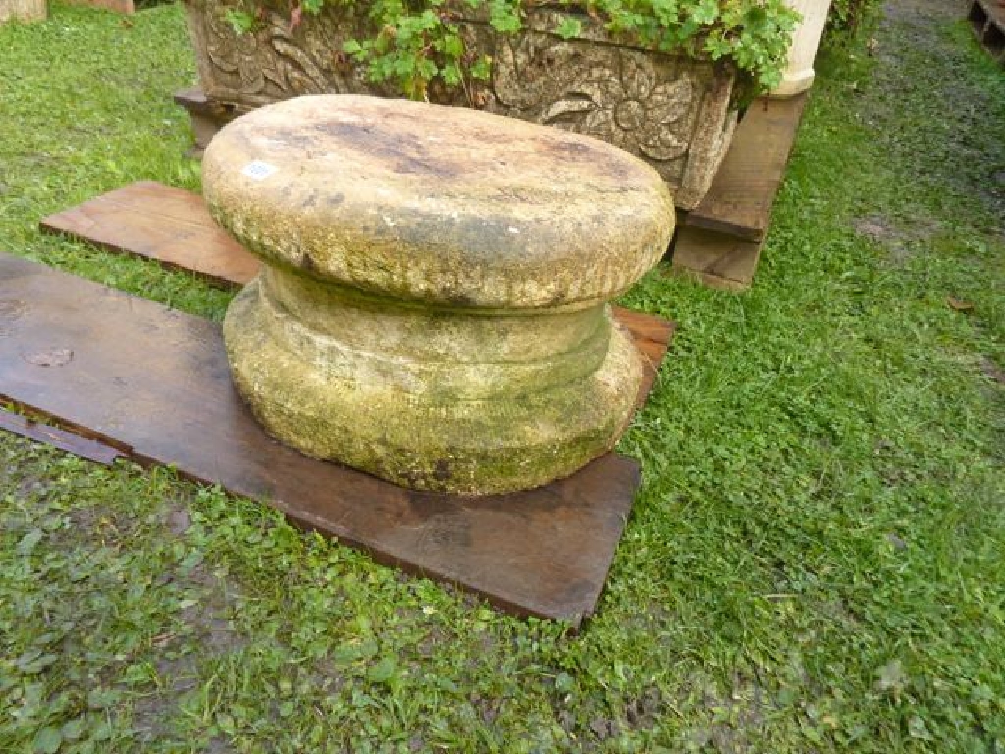 Appraisal: A weathered composition stone plinth of squat circular form together