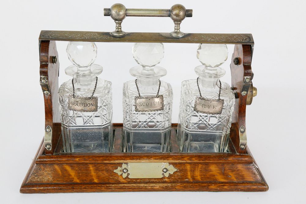 Appraisal: English Oak and Crystal Three-Bottle Tantalus th Century English Oak