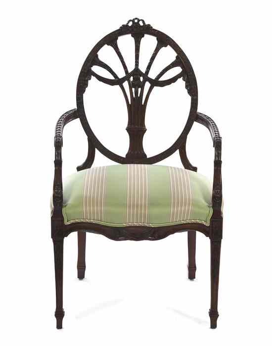 Appraisal: A Neoclassical Mahogany Open Armchair having a ribbon-tied crest over