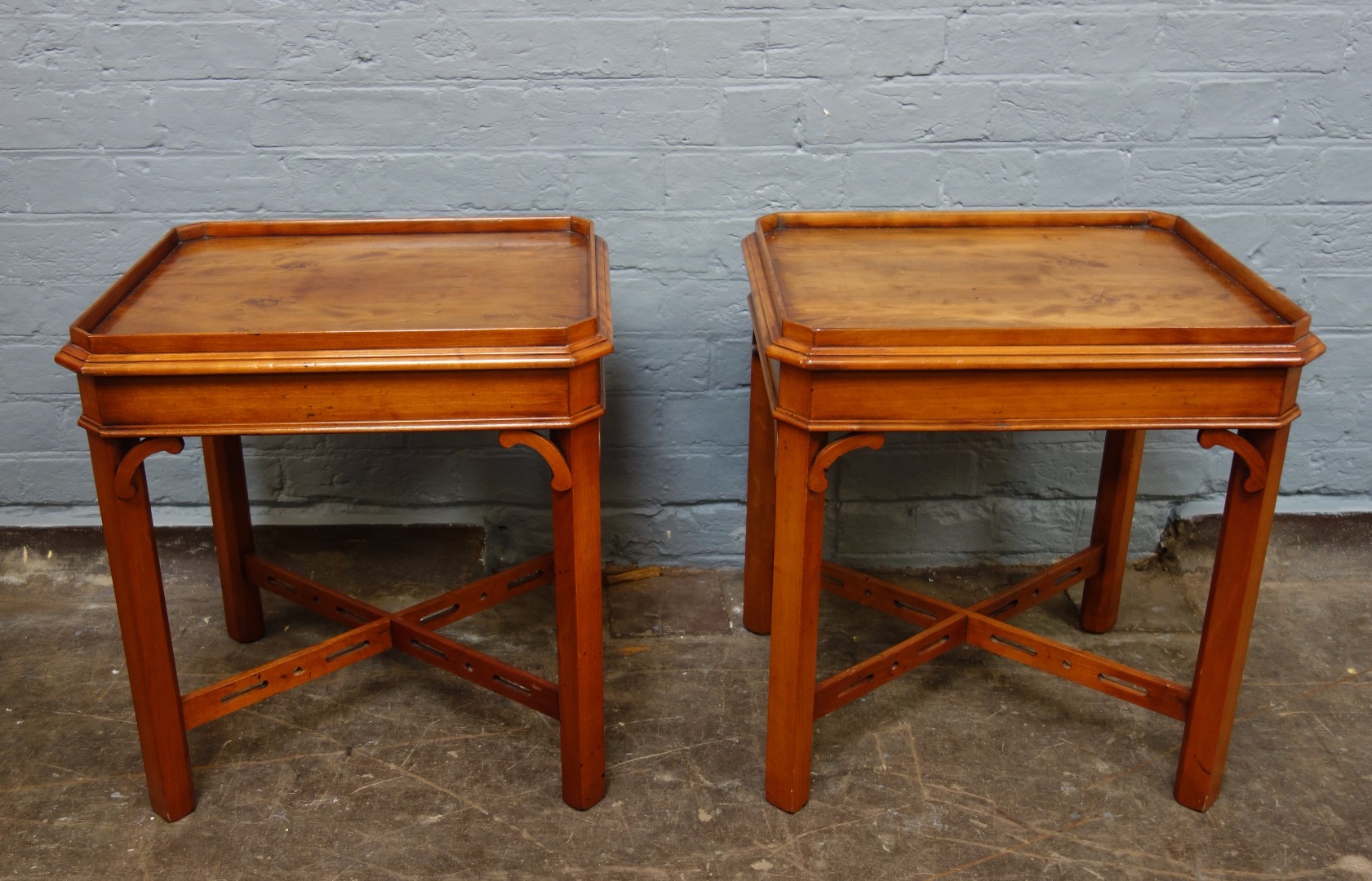 Appraisal: A pair of reproduction yewwood lamp tables in George III