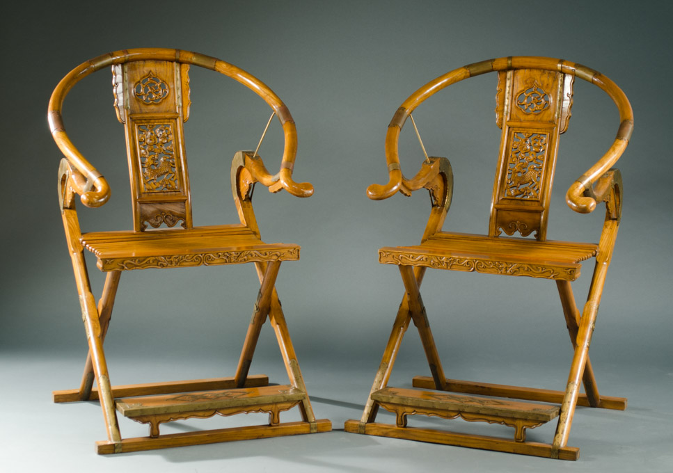 Appraisal: A PAIR OF FOLDING CHINESE CARVED HUANGHUALI PALACE ARMCHAIRS each