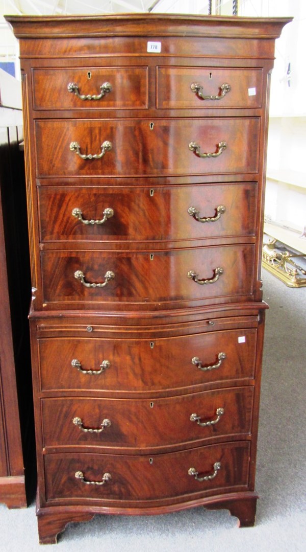 Appraisal: A reproduction mahogany chest on chest the upper with two