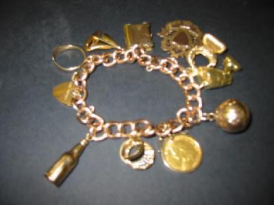 Appraisal: A CT GOLD CHARM BRACELET the flattened curb links hanging