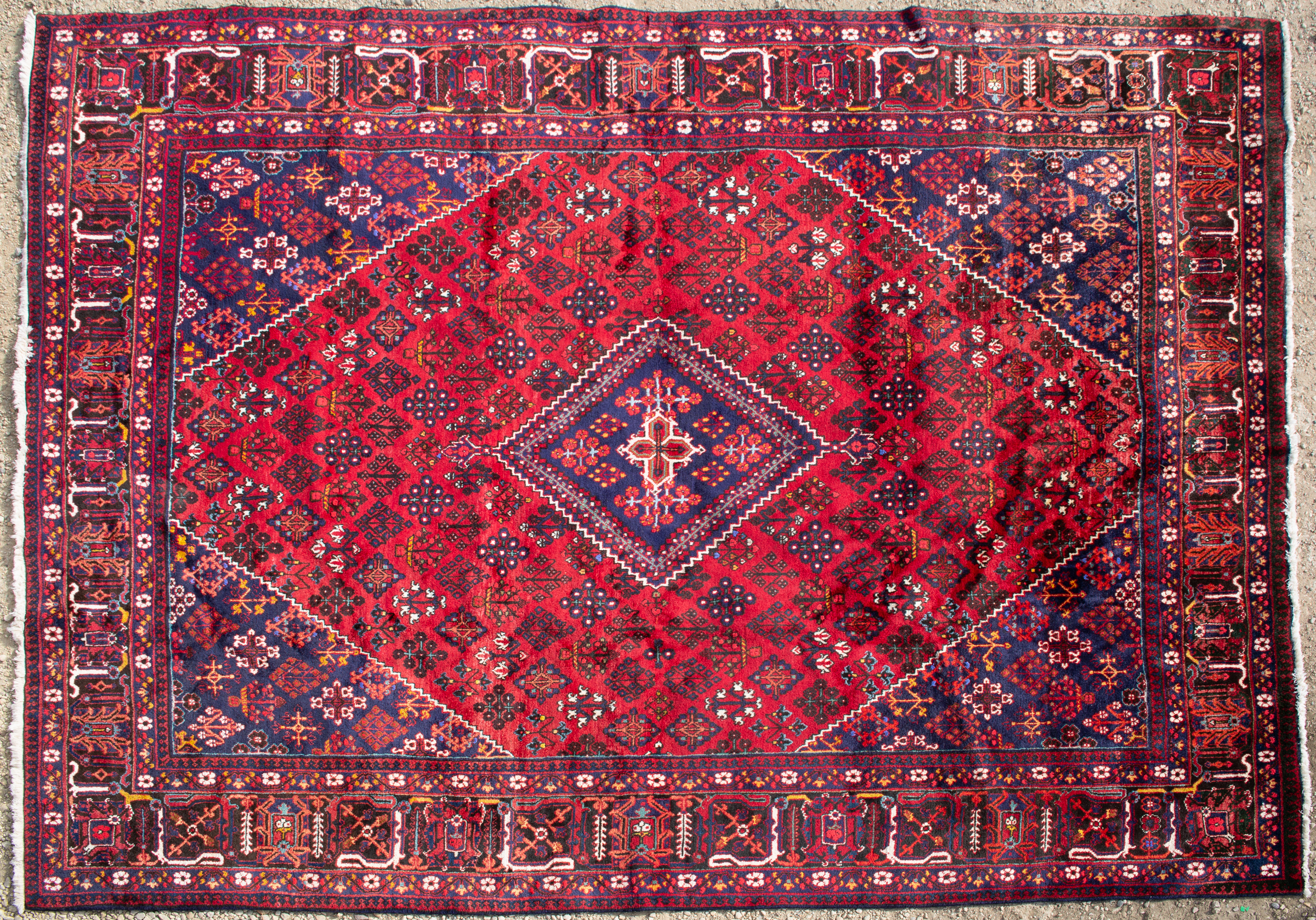 Appraisal: An Oriental red ground large rug with geometric floral designs