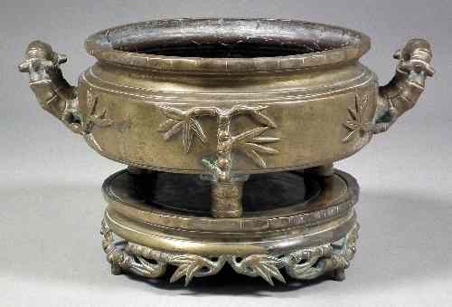 Appraisal: A Chinese bronze two-handled censer and separate stand each cast