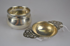 Appraisal: A silver tea strainer on bowl stand Birmingham