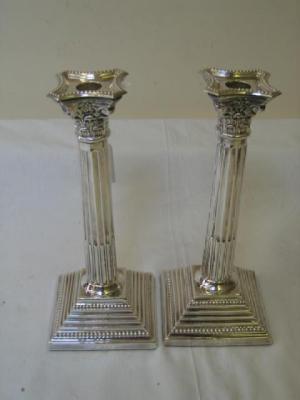 Appraisal: A PAIR OF CANDLESTICKS modelled as Corinthian columns with reeded