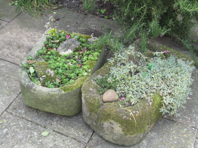 Appraisal: Two bullnose hand hewn stone troughs cm x cm