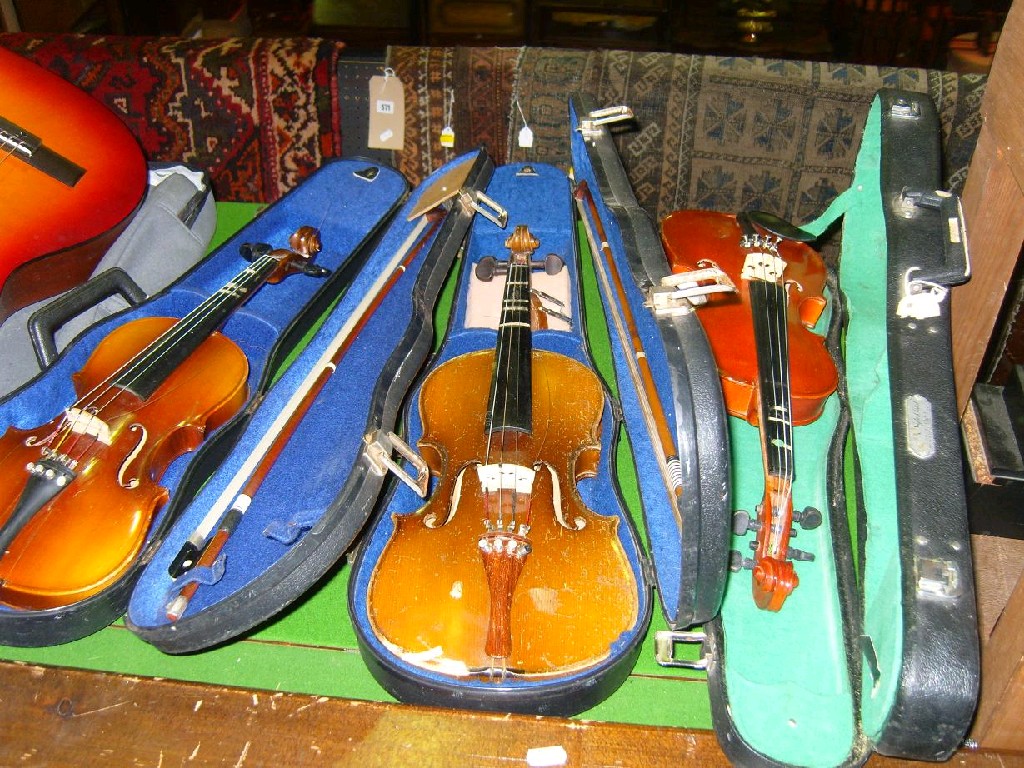 Appraisal: A collection of cased violins all Chinese made together with