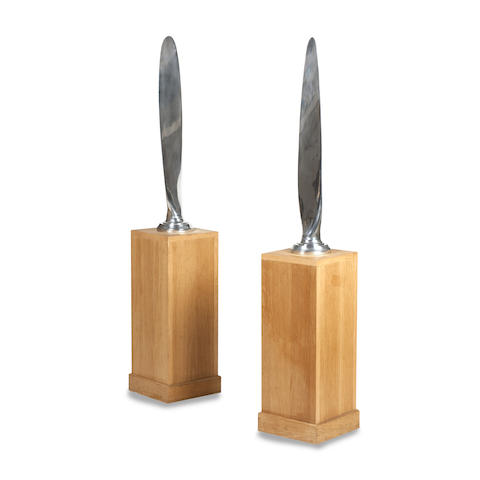 Appraisal: A pair of polished aluminium propellers Each blade raised on