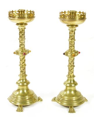 Appraisal: A pair of brass altar candlesticks the knopped stems with