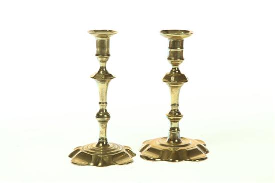 Appraisal: TWO BRASS CANDLESTICKS England th century Similar with petal bases