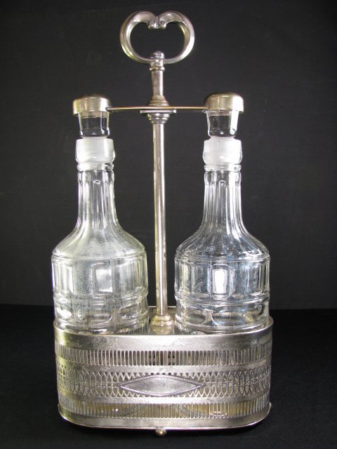 Appraisal: Unusual silver plated tantalus with two clear glass decanters Hallmark