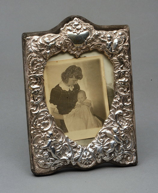 Appraisal: A SILVER PORTRAIT FRAME with a heart shaped aperture and