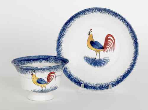 Appraisal: Blue spatter cup and saucer with a rooster th c