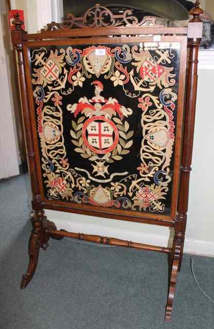 Appraisal: A VICTORIAN ROSEWOOD FIRE SCREEN with carved cresting rail turned