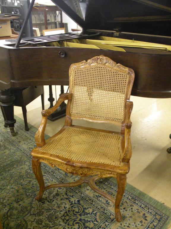 Appraisal: A hardwood bergere type armchair with a caned back and