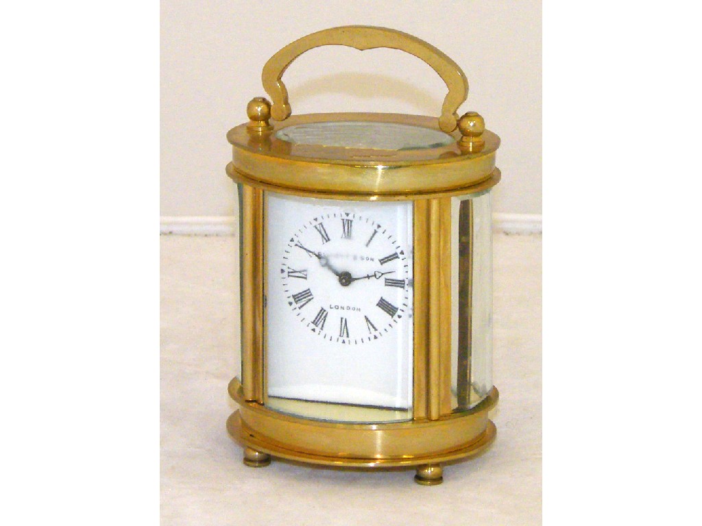 Appraisal: Miniature oval brass cased carriage clock the dial signed Elliott