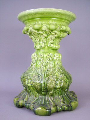 Appraisal: Burmantoft style green glazed jardiniere stand with moulded foliage decoration