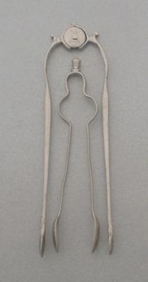 Appraisal: A pair of andiron sugar tongs with a turned finial