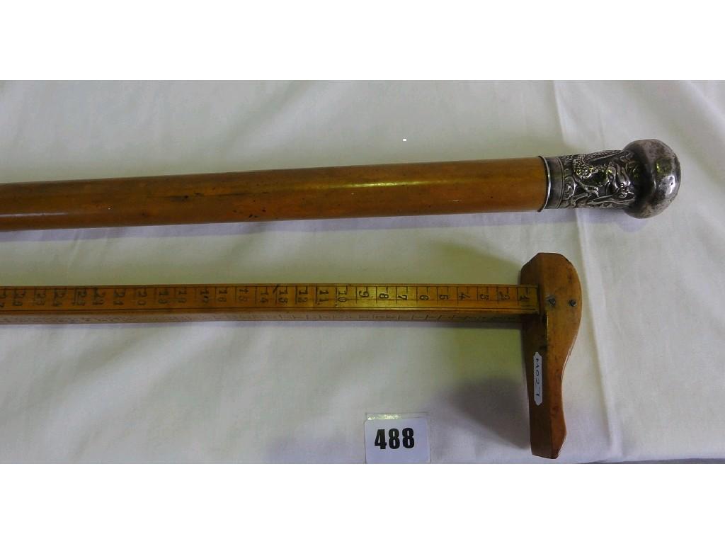 Appraisal: A gentleman's Malacca wood cane with silver knop incised with