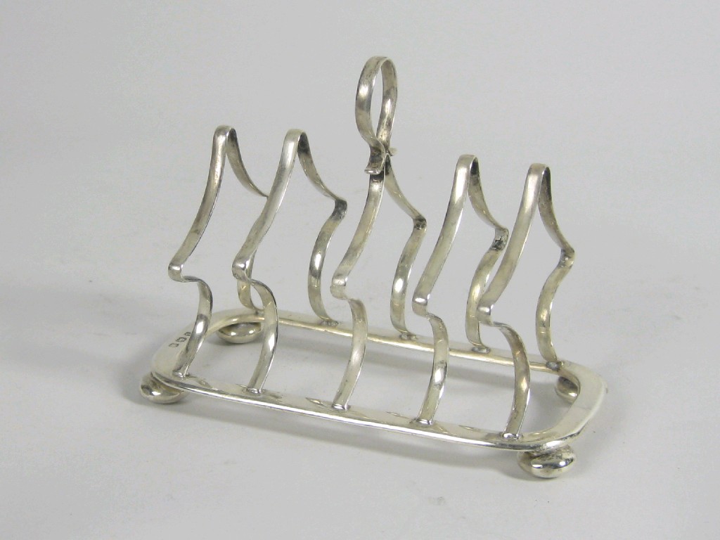 Appraisal: An Edward VII five bar Toast Rack on ball feet