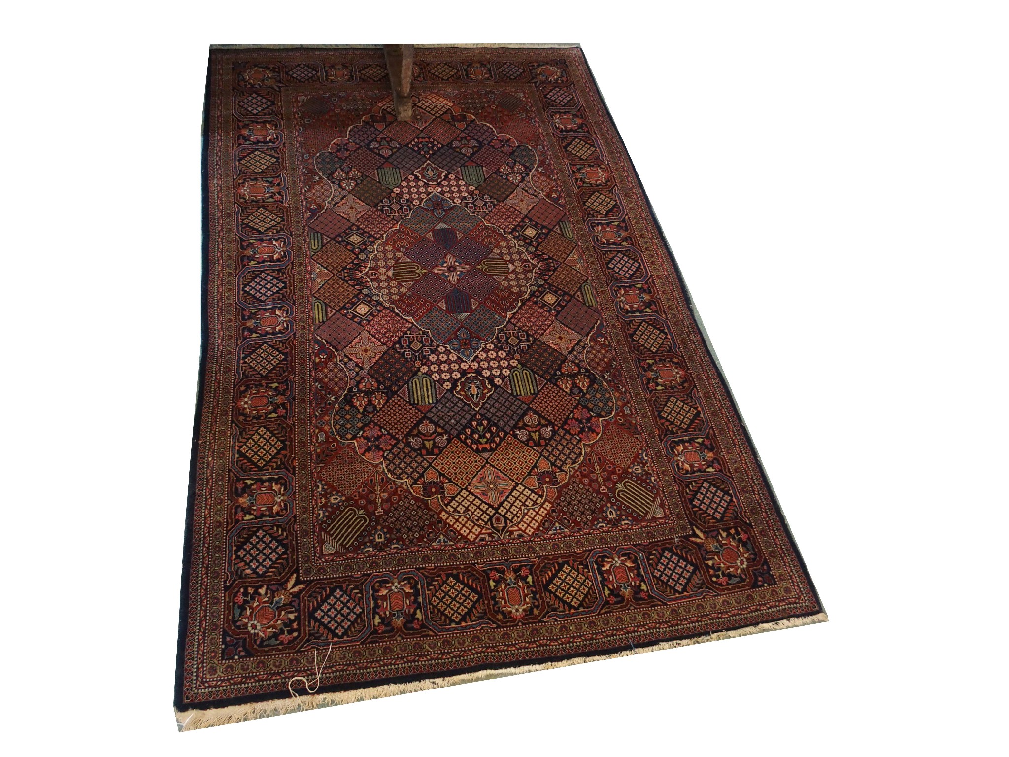 Appraisal: A Persian multi-coloured rugwith geometric patterns x cm