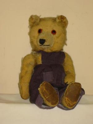 Appraisal: A Chiltern Ting-a-Ling teddy bear covered in worn gold plush