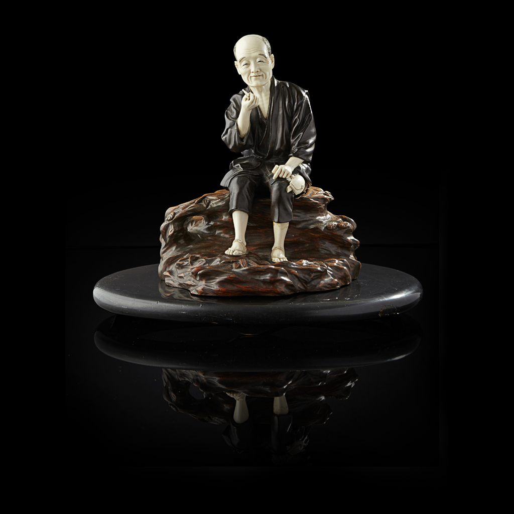 Appraisal: YIVORY AND BRONZE FIGURE OF A MAN SMOKING A PIPE