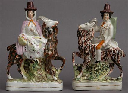 Appraisal: PAIR OF STAFFORDSHIRE FIGURE GROUPS Modeled as a youth and