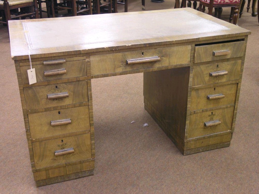 Appraisal: An Art Deco period walnut writing desk inset leather top