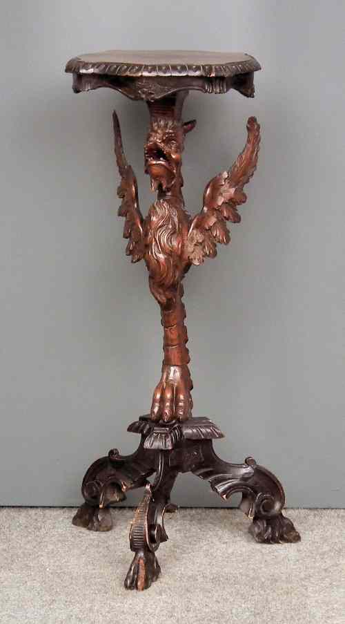 Appraisal: An Italian carved and stained walnut jardiniere stand torchere with