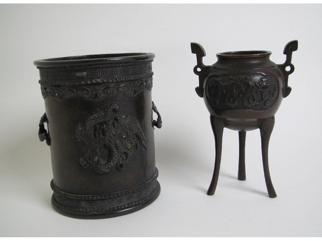 Appraisal: A Chinese bronze cylindrical brush pot cast with dragons and