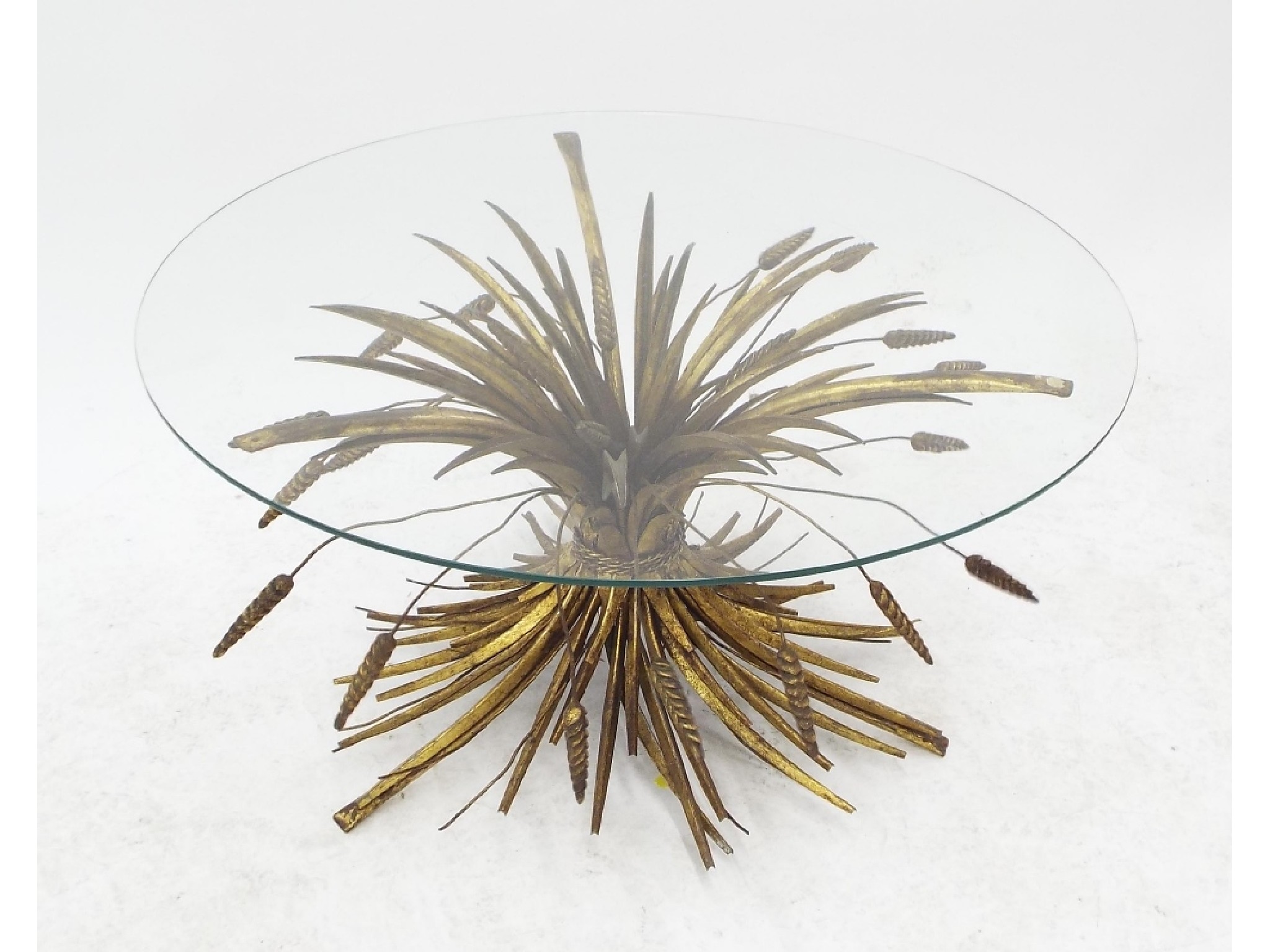 Appraisal: Decorative gilt metal table the diameter glass top upon a