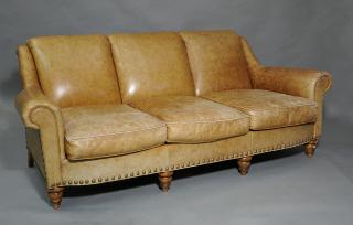 Appraisal: Three cushion light brown leather sofa on turned legs Three