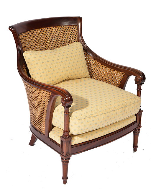 Appraisal: A HARDWOOD BERGERE ARMCHAIR with double caned back and sides