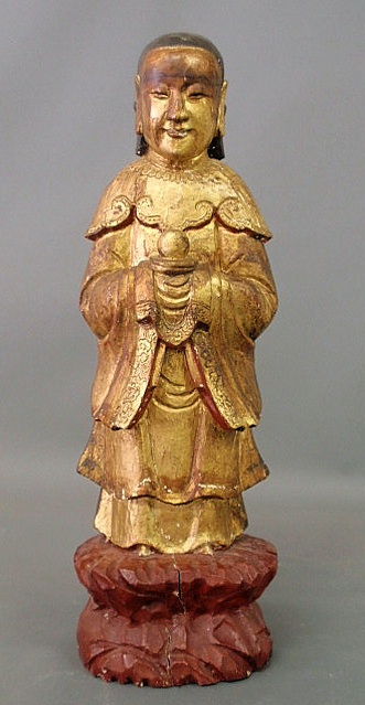 Appraisal: Carved and gilt decorated oriental deity mounted on a red