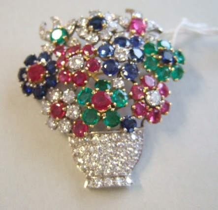 Appraisal: A gold diamond emerald sapphire and ruby set brooch designed