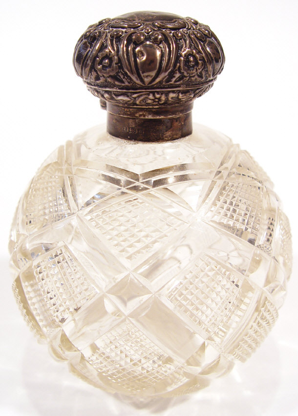 Appraisal: Globular cut glass scent bottle and stopper with embossed silver