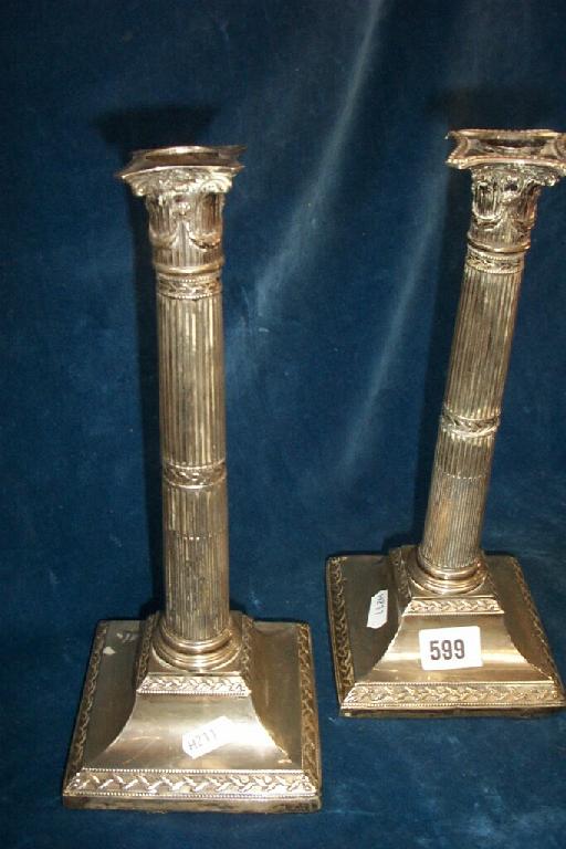 Appraisal: A pair of silver Corinthian column candlesticks with tapering columns