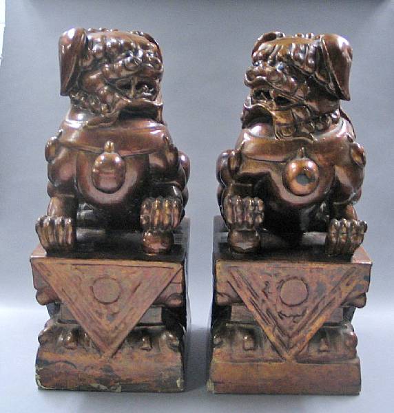 Appraisal: A pair of Chinese lacquered wood fu lion th Century