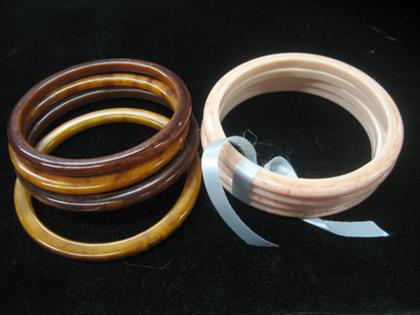 Appraisal: Group of eight bangle bracelets Pink and brown toned colored