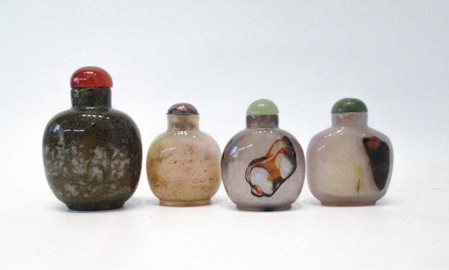 Appraisal: FOUR CHINESE CARVED AGATE SNUFF BOTTLES of compressed and ovoid