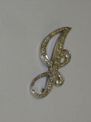 Appraisal: A DIAMOND BROOCH modelled as the letter J set with