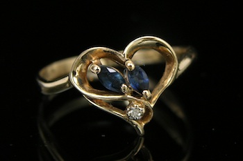 Appraisal: A Dainty Gold Ring with Sapphires and Diamond k yellow