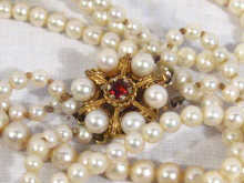 Appraisal: A three row cultured pearl necklace with a carat gold